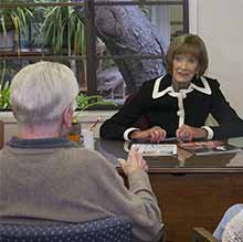 Interactive square, volunteer and member at a desk for volunteer information