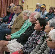 Interactive square, group of members facing forward listening to lecture